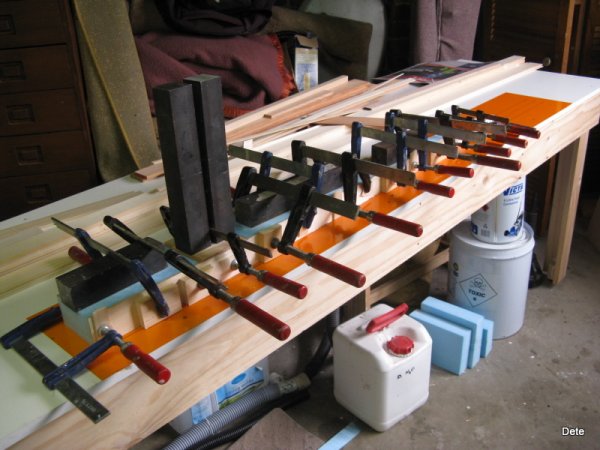 clamping the fin caps to the foam core of the fin post.
